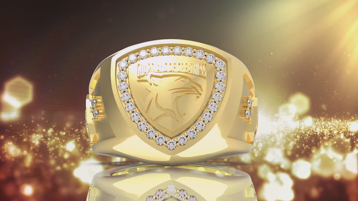 The Guardians of Greatness Signature Ring Spinning on a gold surface.