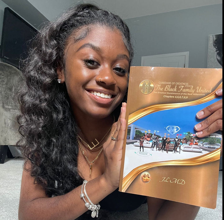 Beautiful Dark woman holding up the book The Black Family United - volume 3. Volume 3 contains chapters 4 to 9.