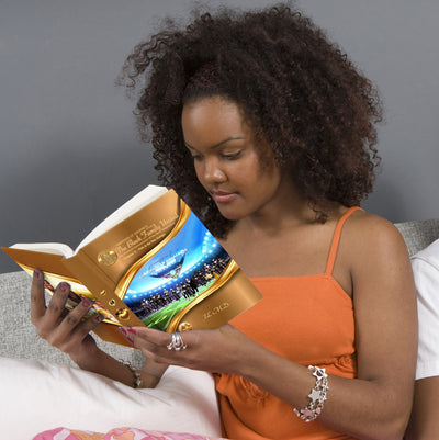 Beautiful Black American woman reading a book.The book is chapter 3 or volume 2 of the book Guardians of Greatness presents the Black Family United - the Greatest Renaissance of the New Millennium.